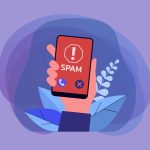 Hand holding smartphone with spam call warning on screen